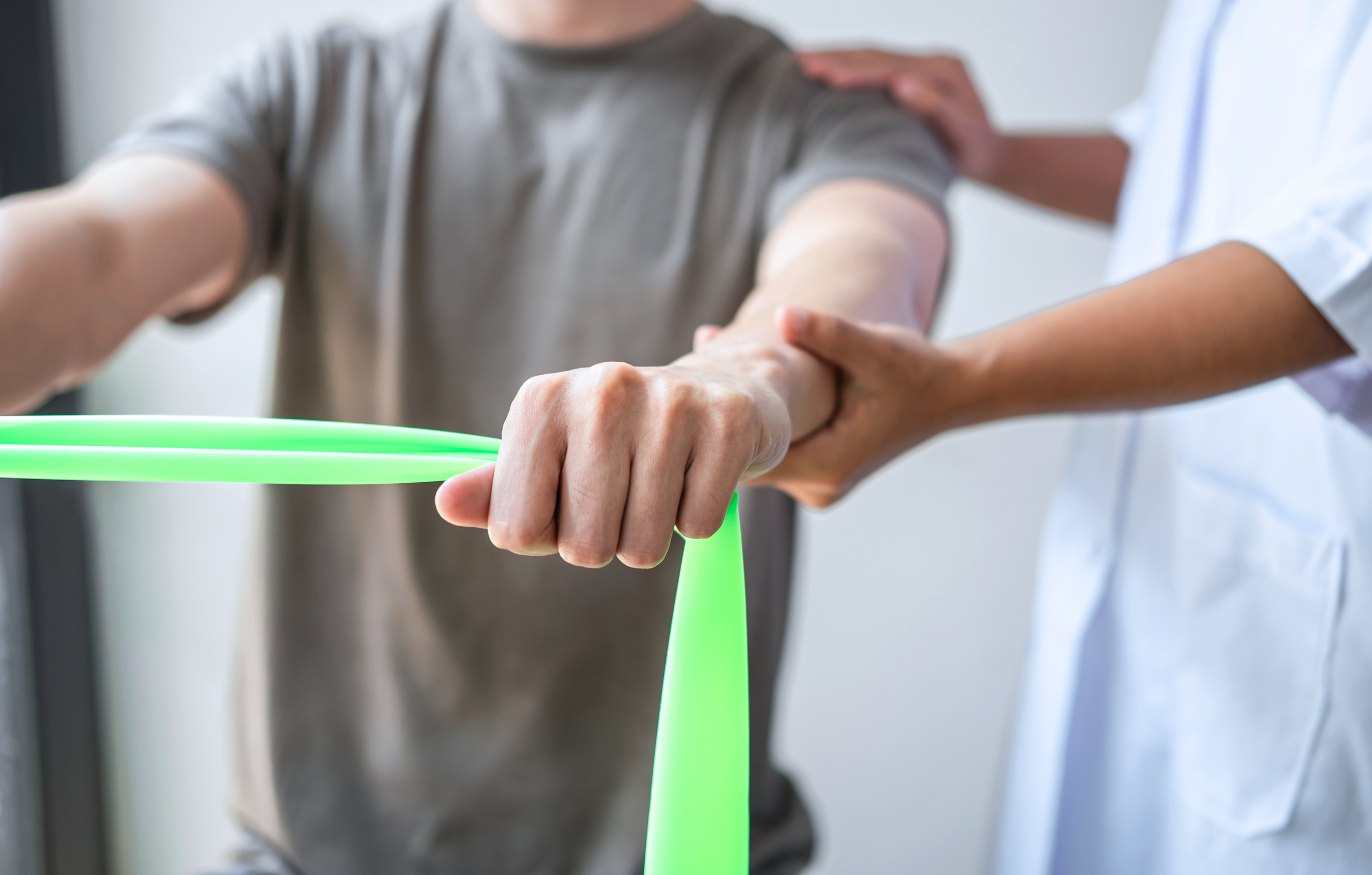 Female Physiotherapist working examining treating injured arm of